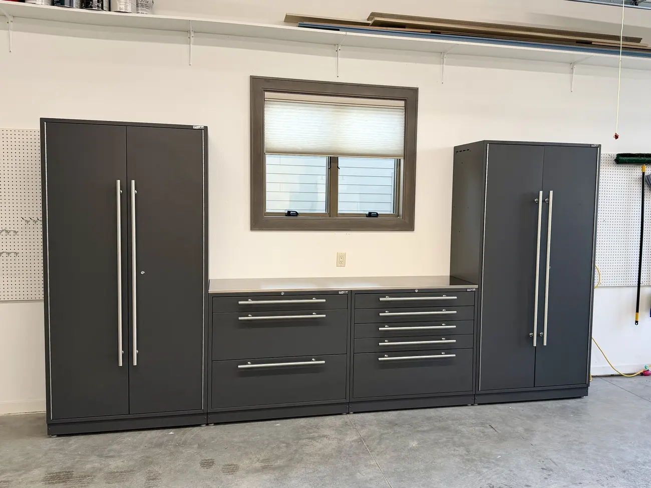 Storm Gray Proslat Lux cabinet wall with two tall cabinets and drawer bases under a window