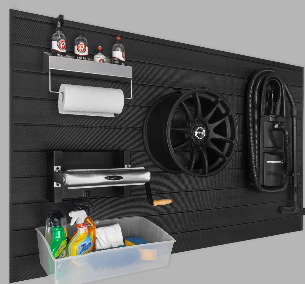 Black carbon fiber PROCORE slatwall with detailing supplies, a wheel and a vacuum