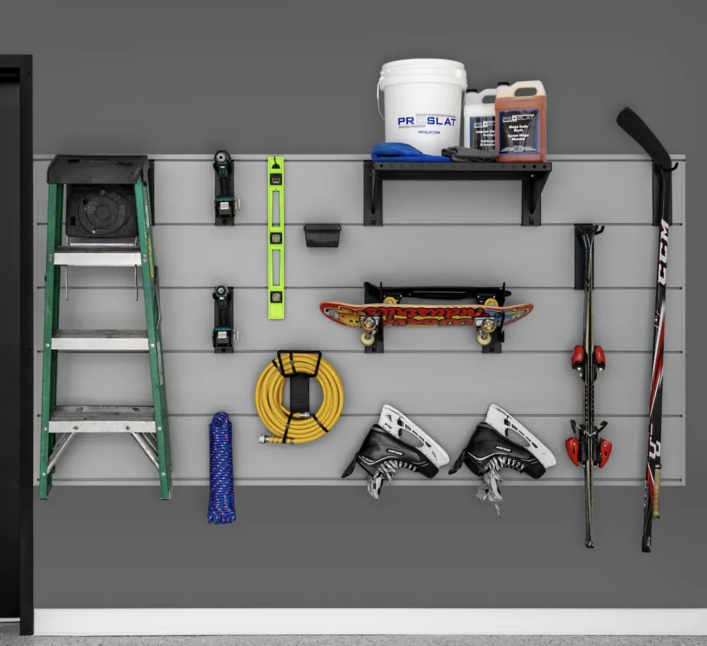 Gray XL PROCORE slatwall holding a ladder, tools, hose, skates, skis and a shelf